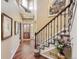 Grand foyer showcasing a beautiful staircase, hardwood floors, and stylish decor at 6435 Spotted Fawn Run, Littleton, CO 80125