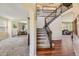 Inviting foyer featuring hardwood floors, a staircase with iron railings, and views to the living spaces at 6435 Spotted Fawn Run, Littleton, CO 80125