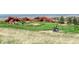 Golf cart on well-kept golf course, with red rock formations and mountain views at 6435 Spotted Fawn Run, Littleton, CO 80125