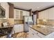A kitchen featuring stainless steel appliances, granite countertops, and white cabinetry at 6435 Spotted Fawn Run, Littleton, CO 80125