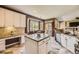 A kitchen with granite countertops, stainless steel appliances, and a kitchen island with seating at 6435 Spotted Fawn Run, Littleton, CO 80125
