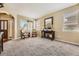 Cozy living room with neutral carpet, large windows, and elegant furnishings at 6435 Spotted Fawn Run, Littleton, CO 80125