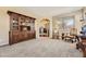 Spacious living room with a large cabinet, seating, and an arched doorway at 6435 Spotted Fawn Run, Littleton, CO 80125