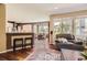 A living room with an open floor plan showcasing the kitchen and dining area at 6435 Spotted Fawn Run, Littleton, CO 80125