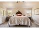 Bright main bedroom with carpeted floors, ceiling fan, and decorative headboard at 6435 Spotted Fawn Run, Littleton, CO 80125