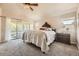 Spacious main bedroom with vaulted ceiling, fan, and sliding glass doors to deck at 6435 Spotted Fawn Run, Littleton, CO 80125