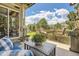 A cozy outdoor patio with comfortable seating and views of the lush backyard at 6435 Spotted Fawn Run, Littleton, CO 80125