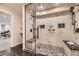 Luxurious glass enclosed shower with marble tiling, a bench, and multiple shower heads at 6435 Spotted Fawn Run, Littleton, CO 80125