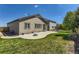 Inviting backyard features a concrete patio, lawn, and wooden fence, ideal for outdoor activities and relaxation at 17720 Weymouth Ave, Parker, CO 80134