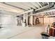 Unfinished basement ready to be updated, with white walls, exposed ceiling and concrete floor at 17720 Weymouth Ave, Parker, CO 80134