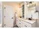 Bright bathroom with double sinks, granite counters, and modern lighting at 17720 Weymouth Ave, Parker, CO 80134