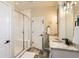 Well-lit bathroom featuring a glass shower, double sinks, and granite countertops at 17720 Weymouth Ave, Parker, CO 80134