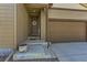 Inviting front entrance with a welcoming door and convenient attached two-car garage at 17720 Weymouth Ave, Parker, CO 80134