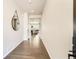 Bright hallway featuring hardwood floors and a view into the living room at 17720 Weymouth Ave, Parker, CO 80134