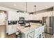 Modern kitchen with white cabinets, stainless steel appliances, and a granite island at 17720 Weymouth Ave, Parker, CO 80134
