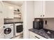 Functional laundry room with washer, dryer, built-in storage, and stylish countertops at 17720 Weymouth Ave, Parker, CO 80134