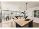 Open floor plan featuring a granite kitchen island and views into the adjacent living and dining rooms at 17720 Weymouth Ave, Parker, CO 80134