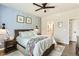 Cozy main bedroom with stylish decor, ceiling fan, and an adjacent bathroom at 17720 Weymouth Ave, Parker, CO 80134