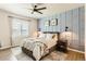 Stylish main bedroom with a decorative wall, ceiling fan, and bright natural light at 17720 Weymouth Ave, Parker, CO 80134