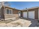 Exterior backyard features stucco walls, double garage door, door, and concrete pavement at 2060 W Iliff Ave, Englewood, CO 80110