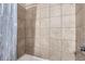Tiled shower showing the beautiful neutral tile and fixtures at 2060 W Iliff Ave, Englewood, CO 80110