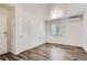 Clean bedroom with neutral walls, wood floors, a window providing natural light, and AC unit at 2060 W Iliff Ave, Englewood, CO 80110