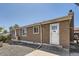 Cozy one-story home featuring a stucco exterior, front door, and well-maintained landscaping at 2060 W Iliff Ave, Englewood, CO 80110