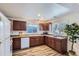 Well-lit kitchen featuring warm cabinets, modern appliances, and a large window at 2060 W Iliff Ave, Englewood, CO 80110