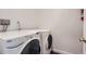 Bright laundry room featuring a modern washer and dryer set at 2060 W Iliff Ave, Englewood, CO 80110