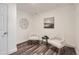 Bright sitting area with two striped chairs and an art piece over a black side table at 2060 W Iliff Ave, Englewood, CO 80110
