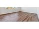 Bright, empty bedroom with wood-look flooring and large, light-filled windows at 9852 Cathay St, Commerce City, CO 80022
