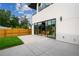Home's backyard showcasing sliding glass doors to the home, a concrete patio and some grass at 1601 S Columbine St, Denver, CO 80210