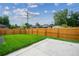 Large grassy backyard features a tall wooden fence and a concrete patio area at 1601 S Columbine St, Denver, CO 80210