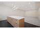 Open basement area with kitchenette featuring sleek cabinetry and a quartz countertop at 1601 S Columbine St, Denver, CO 80210