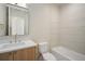 Modern bathroom featuring white countertops, wood cabinets, and a tile surround at 1601 S Columbine St, Denver, CO 80210