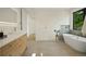 Serene bathroom featuring a soaking tub, modern vanity, and a minimalist design at 1601 S Columbine St, Denver, CO 80210