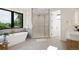 Elegant bathroom with a freestanding tub, a glass-enclosed shower, and upscale fixtures at 1601 S Columbine St, Denver, CO 80210