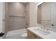 Well-lit bathroom featuring a modern sink, mirror and stylish horizontal tiling around a shower-tub combination at 1601 S Columbine St, Denver, CO 80210