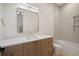 Bathroom featuring a modern vanity with white countertop, light-wood cabinets, and a stylish mirror and bathtub at 1601 S Columbine St, Denver, CO 80210