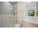 Modern bathroom with glass enclosed shower, and a wood vanity with white countertop at 1601 S Columbine St, Denver, CO 80210