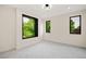 Bright bedroom with large windows offering beautiful tree views and soft grey carpet at 1601 S Columbine St, Denver, CO 80210