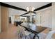 Open-concept dining room with modern lighting, wood flooring, and an elegant dining set at 1601 S Columbine St, Denver, CO 80210