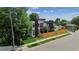 Modern two-story home with a combination of white, brown, and dark gray elements and a wood fence at 1601 S Columbine St, Denver, CO 80210