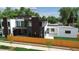 Modern two-story home with a combination of white, brown, and dark gray elements and a wood fence at 1601 S Columbine St, Denver, CO 80210