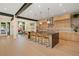 Open kitchen and dining area with island, pendant lighting, and stainless steel appliances at 1601 S Columbine St, Denver, CO 80210