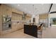 Spacious kitchen featuring stainless steel appliances, custom cabinetry, and a large island with seating at 1601 S Columbine St, Denver, CO 80210