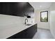 This Laundry room features black cabinets, white countertops, and a stainless steel sink at 1601 S Columbine St, Denver, CO 80210