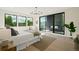 Bright main bedroom with a sliding glass door, plush bedding, and a calming color palette at 1601 S Columbine St, Denver, CO 80210