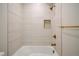 This shower features white tile surround, brushed gold fixtures, and a built-in niche at 1601 S Columbine St, Denver, CO 80210