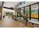Modern staircase with sleek black railings, wood steps, and large windows offering abundant natural light at 1601 S Columbine St, Denver, CO 80210